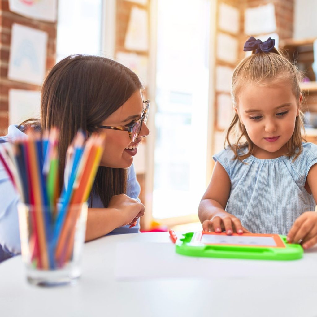 Image of an educator with a child at a daycare, preschool or kindergarten.